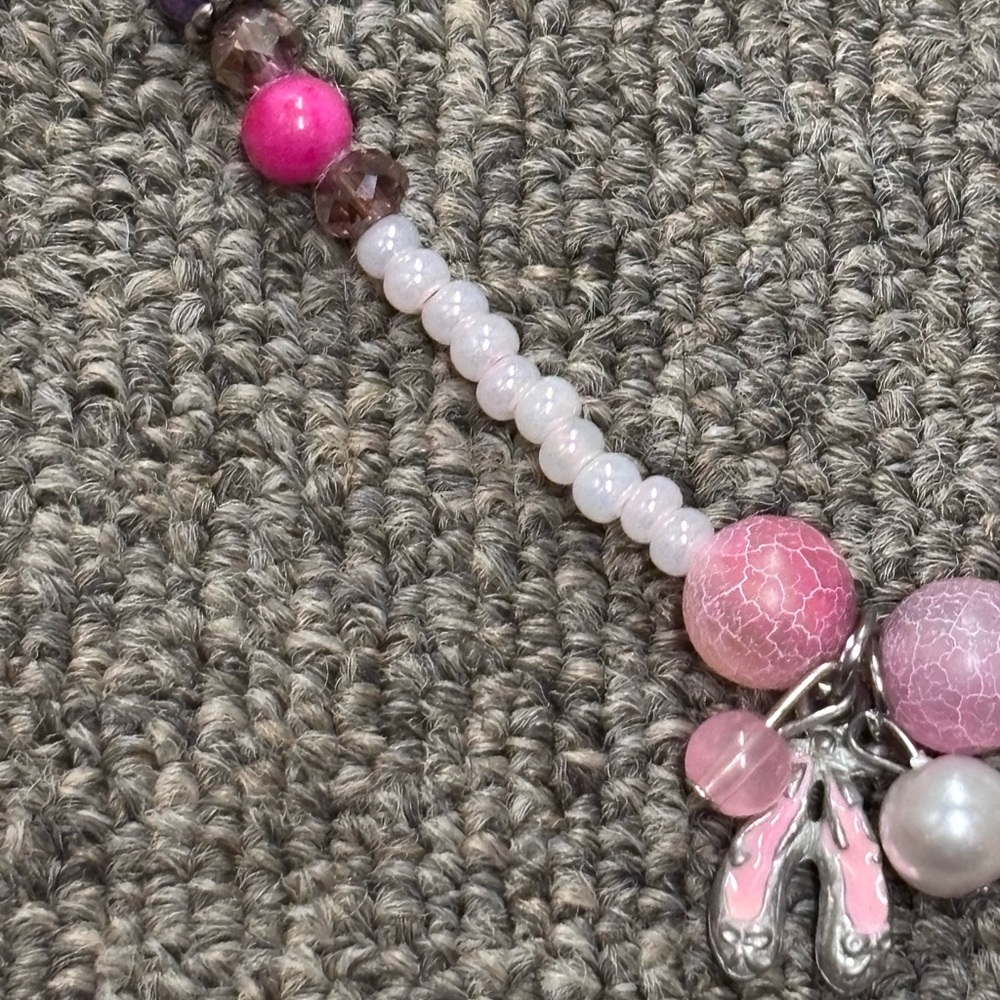 Homemade ballerina necklace with pink and white beads